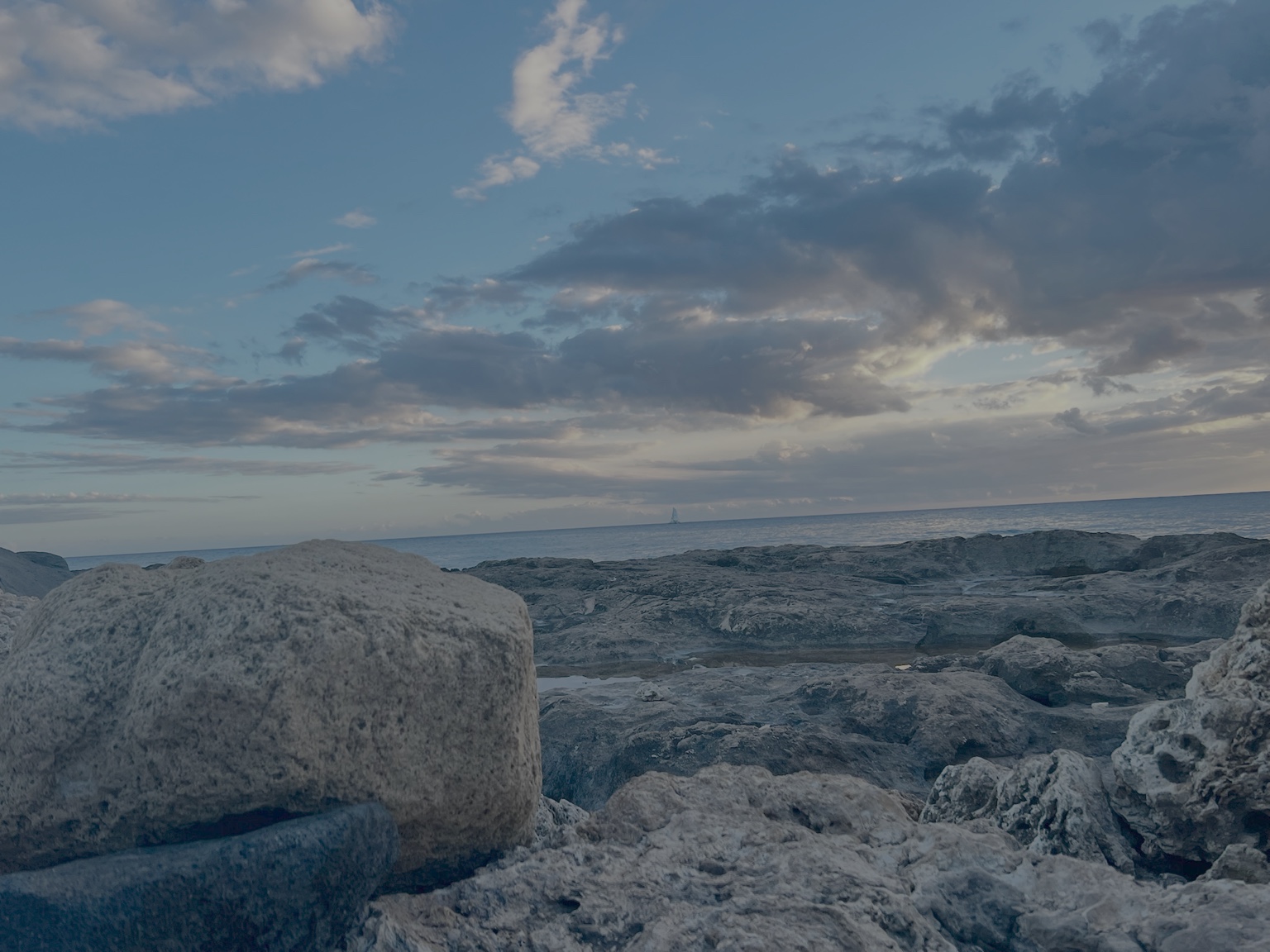 Shoreline with clouds and lava rock